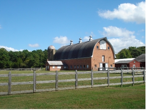 A plan will be developed to determine
the long-term use of the City Farm site. City Farm Barn.svg
